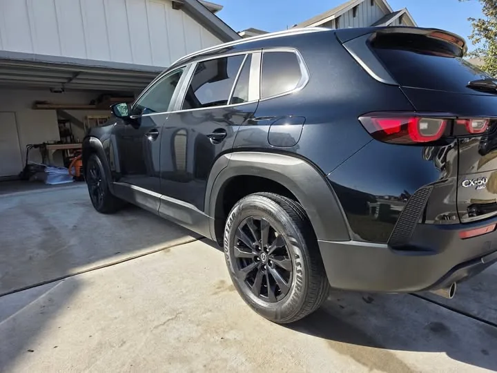 Black Mazda CX-50 detailed and shining in the driveway