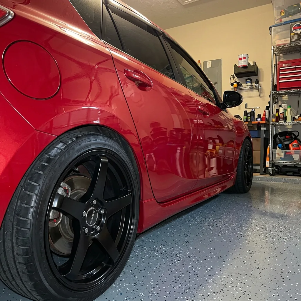 Side profile of red Mazdaspeed 3 with polished black wheels