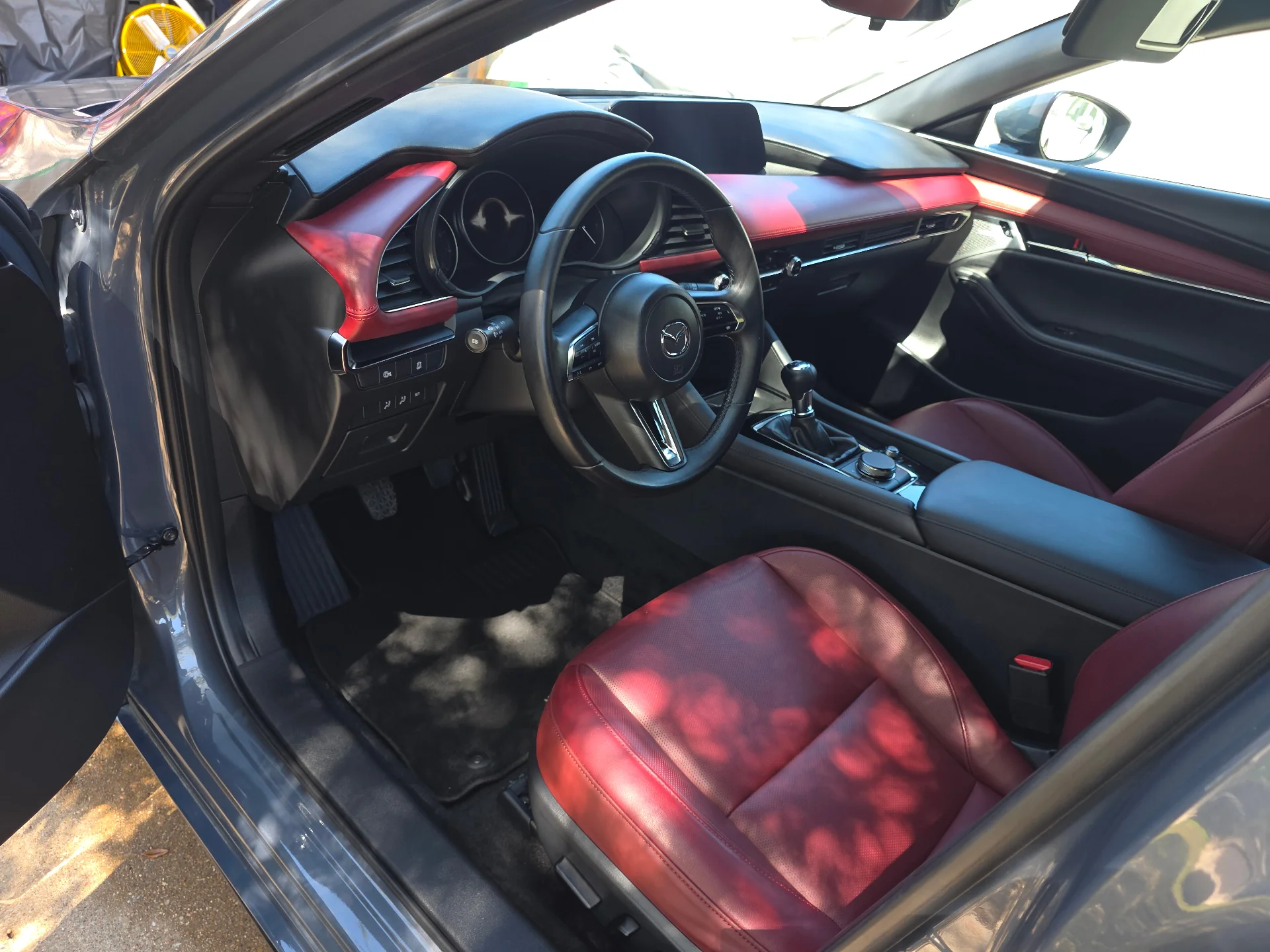 Detailed Mazda 3 interior with red leather seats and clean dashboard