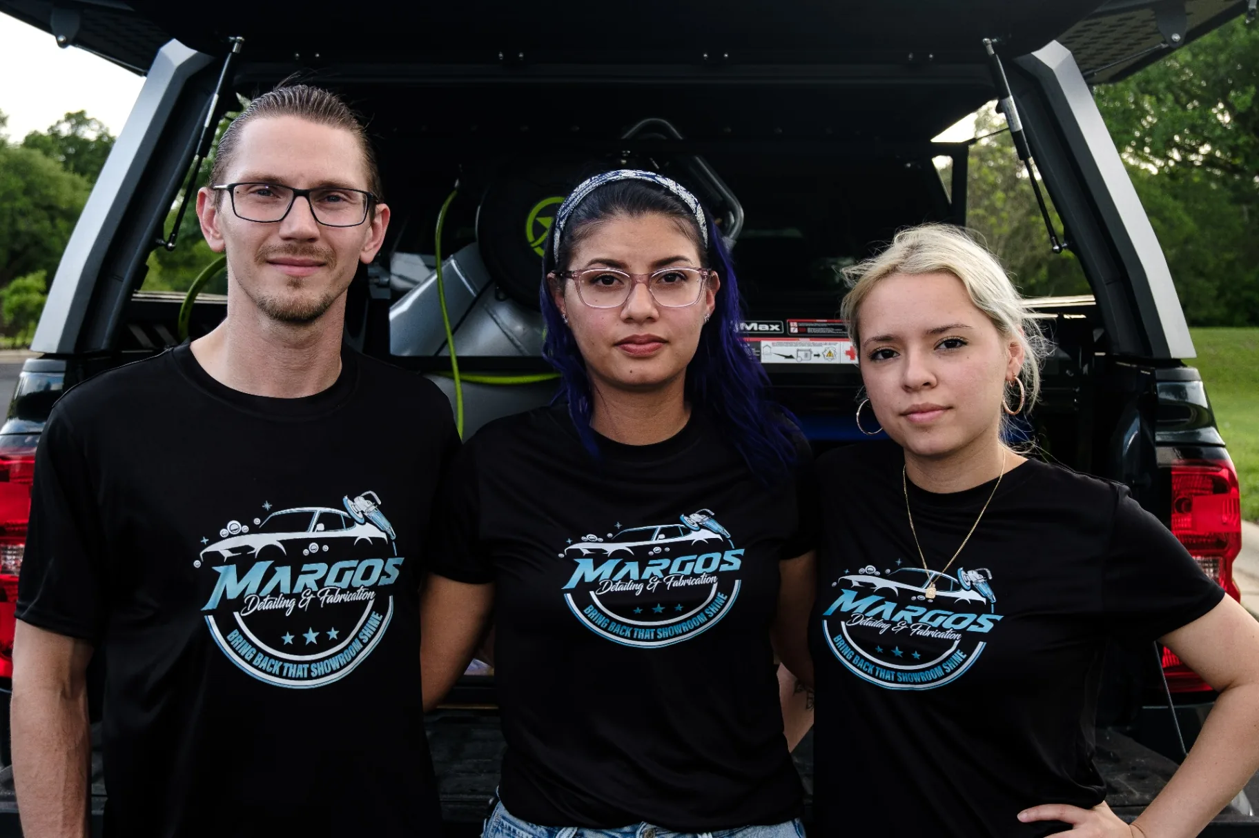 The Margos Detailing team posing at the back of the work truck